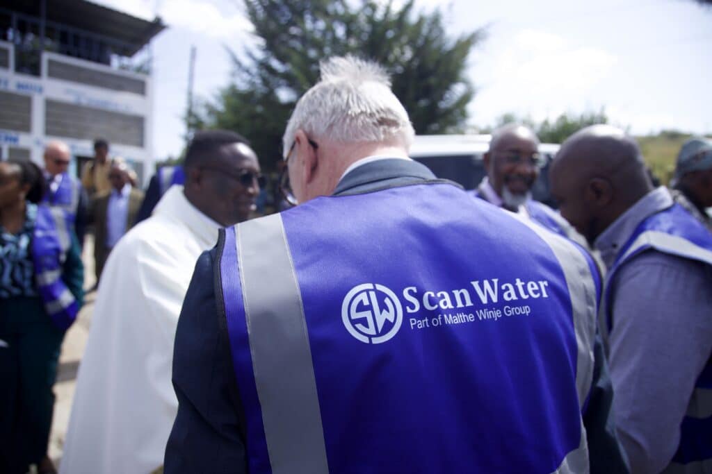 Persons in ScanWater apparel present at showcase.